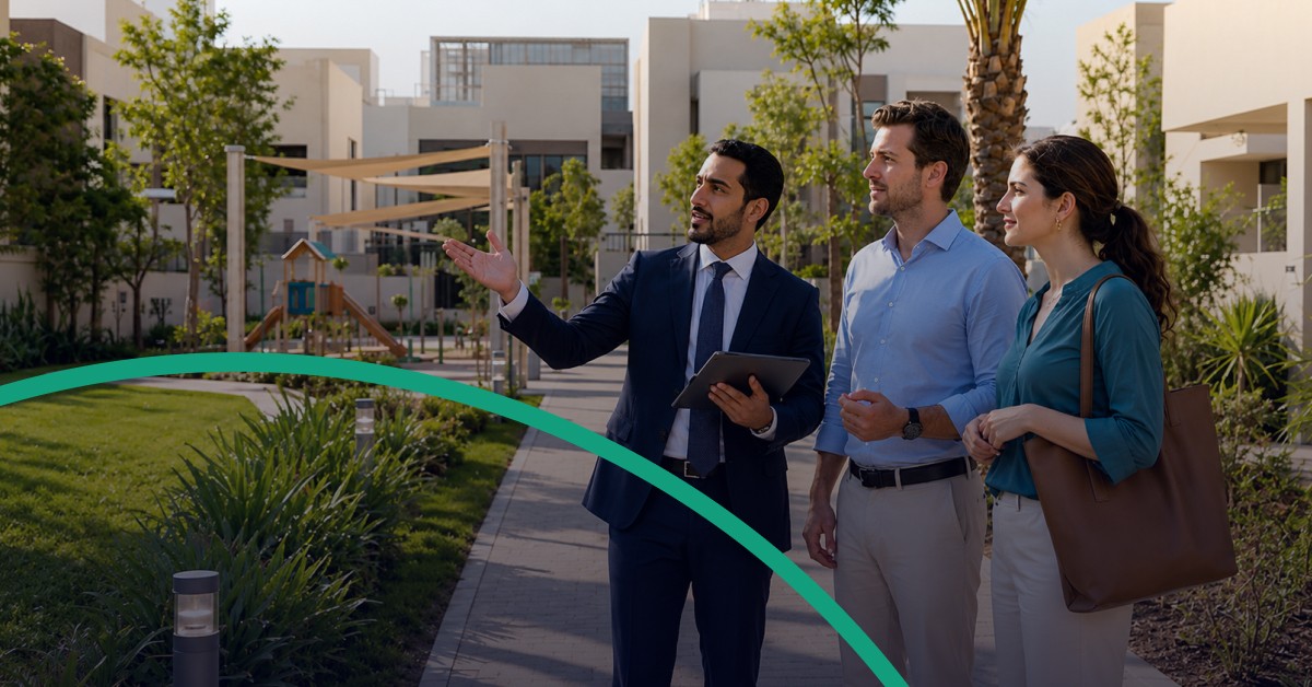 Real estate advisor showing a couple around a landscaped residential community.